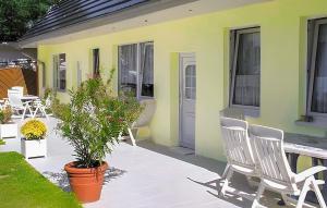 a patio with chairs and a table and a house at 2 Bedroom Lovely Apartment In Ostseebad Breege Ot Ju in Drewoldke