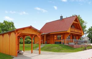 a large wooden house with a gazebo at 3 Bedroom Lovely Home In Tollenseheim in Krickow