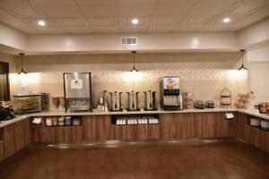 a coffee shop with a counter with a coffee maker at Ontario Airport Inn in Ontario