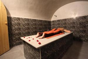 a man laying on a bath tub with roses on the floor at THE FARM LODGES & Private pool in Marrakech