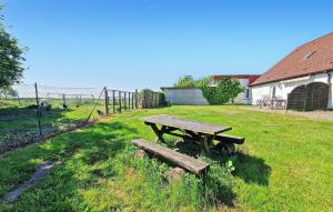 a picnic table sitting in the grass in a field at 3 Bedroom Cozy Home In Blankensee Ot Watzkend in Blankensee