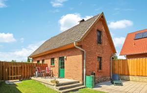 a brick house with a green door and a fence at 1 Bedroom Cozy Home In Jabel Ot Loppin in Loppin