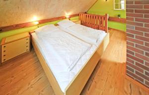 a large bed in a room with a brick wall at 1 Bedroom Cozy Home In Jabel Ot Loppin in Loppin