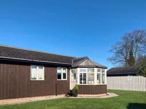 a house with a fence and a yard at The Beeches in Warkworth