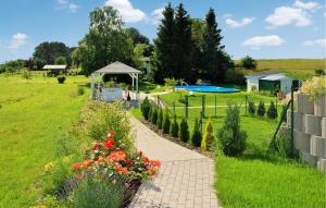 a garden with a pathway and a gazebo at Nice Apartment In Neppermin-usedom With Kitchen in Neppermin