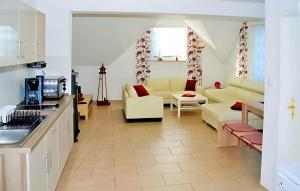 a kitchen and a living room with a couch at Nice Apartment In Neppermin-usedom With Kitchen in Neppermin