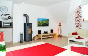 a living room with a fireplace and a red rug at Nice Apartment In Neppermin-usedom With Kitchen in Neppermin