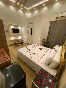 a bedroom with a bed with red hearts on it at Meramees Hotel in Cairo