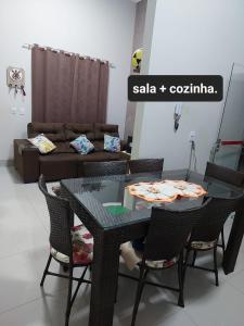 a table and chairs in a living room with a couch at Casa de temporada in Rio Verde