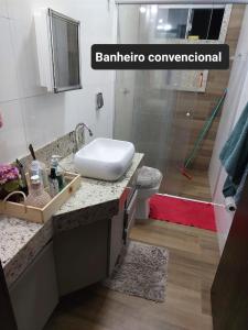 a bathroom with a sink and a shower at Casa de temporada in Rio Verde