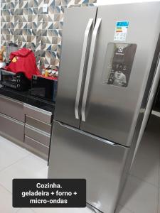 a stainless steel refrigerator in a kitchen at Casa de temporada in Rio Verde