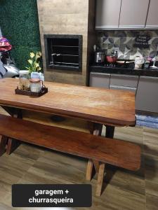 a wooden table and bench in a kitchen at Casa de temporada in Rio Verde