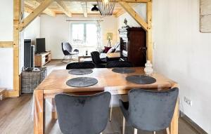 a living room with a wooden table and chairs at Ferienhaus Altwarp in Altwarp