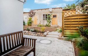 a wooden bench sitting in front of a house at Ferienhaus Altwarp in Altwarp +24 photos