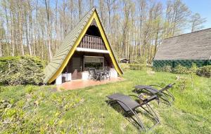 a small house with a triangular roof in the grass at 2 Bedroom Stunning Home In Templin Ot Ahrensdorf in Albrechtsthal