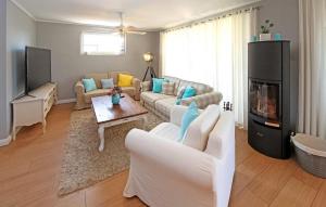 a living room with a couch and a fireplace at Amazing Home In Zecherin With Wifi in Zecherin