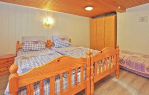 two wooden beds in a room with wooden floors at Nice Home In Waren mritz With Kitchen in Warenshof