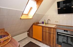 a small kitchen with a sink and a window at Gorgeous Apartment In Userin With Wifi in Userin