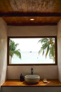 a bathroom window with a sink and a view of the beach at Seaworthy Boracay in Boracay