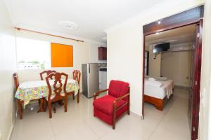 a room with a table and chairs and a bedroom at Tropical Island Aparthotel, Budget Rooms & Family Apartment Rentals in Santo Domingo