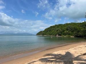 a view of a beach with trees and the ocean at Le Shelby Samui Beach Resort Cottage in Koh Samui