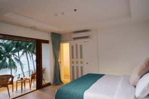 a bedroom with a bed and a view of the ocean at Seaworthy Boracay in Boracay