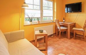 a living room with a couch and a table and a television at Ferienwohnung Malchow in Malchow