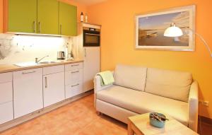 a living room with a couch and a kitchen at Ferienwohnung Malchow in Malchow