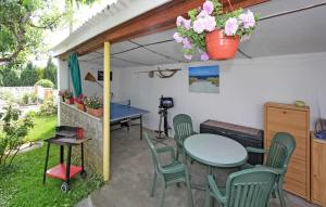 a patio with a table and chairs and a table at Cozy Home In Eggesin With Kitchen in Eggesin