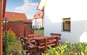 a patio with a wooden table and two benches at 1 Bedroom Gorgeous Home In Feldberger Seenlandsch in Feldberg