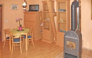 a wood stove in a room with a table at Gorgeous Apartment In Mnkebude With Wifi in Mönkebude