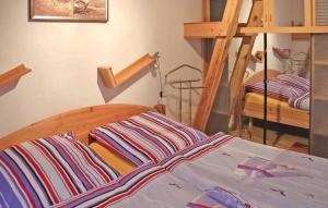 a bedroom with a bed and two bunk beds at Gorgeous Apartment In Mnkebude With Wifi in Mönkebude