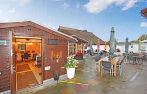 a restaurant with a patio with tables and chairs at Gorgeous Apartment In Greifswald-wieck With Wifi in Wieck