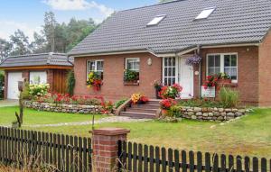 a brick house with flowers in the front yard at Gorgeous Apartment In Schwarzenhof With Wifi in Schwarzenhof