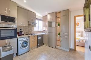 a kitchen with a washer and dryer at Luxury Living Flat in Prestigia Marrakech in Marrakesh