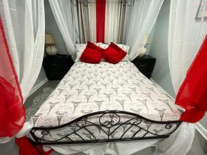a bedroom with a bed with red pillows on it at Nice one bedroom apartment at 15 minutes to New York excellent bus transportation in North Bergen