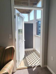 a room with a balcony with a window and a couch at Luxury 1BR/1BA w/ Top Amenities in Prime Location in Fort Wayne