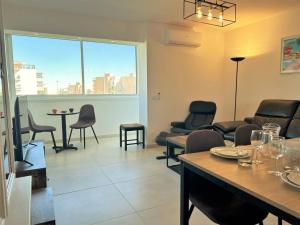 d'un salon avec une table et des chaises ainsi que d'une chambre avec une fenêtre. dans l'établissement Appartement 3 pièces refait à neuf avec parking, 4 couchages, proche plage et commerces - Le Lavandou - FR-1-251-584, au Lavandou 9 autres photos