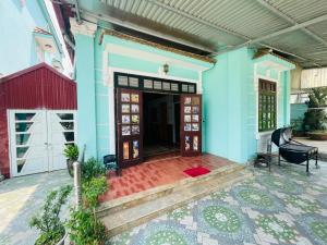 une maison bleue avec une porte et une terrasse couverte dans l'établissement Cyan Sapa Homestay, à Sa Pa