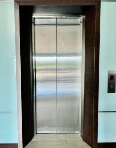 a stainless steel door with a view of the ocean at Chariton Hotel Nusa Bestari in Johor Bahru