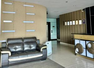 a lobby with a leather couch in a room at Chariton Hotel Nusa Bestari in Johor Bahru +16 photos