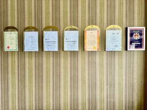 a row of signs hanging on a wall at Chariton Hotel Nusa Bestari in Johor Bahru