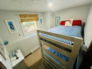 a bedroom with a bunk bed in a room with a window at Clear Pond Getaway in Plymouth