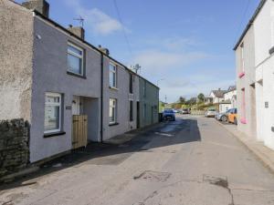 an empty street with houses on the side of the road at Crag View Cottage in Barrow in Furness