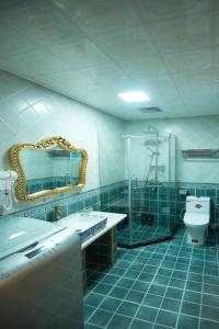 a bathroom with a sink and a shower and a toilet at Yi Jiang Lou lnn in Fenghuang County