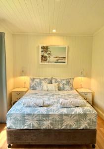 a bedroom with a bed with two pillows on it at Spacious 5 BR Family Home with free WIFI & AC pet friendly in Bundaberg