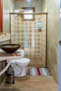 a bathroom with a shower with a toilet and a sink at Pouso Du Ferreiro in Tiradentes +23 photos