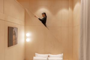 a woman standing on a staircase in a room at The Hyoo Sik ANNK Hong Dae Branch in Seoul