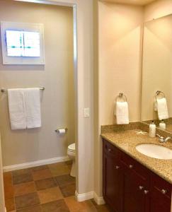 een badkamer met een wastafel, een toilet en een spiegel bij Resort King Studio with Private Balcony 064622 in La Quinta