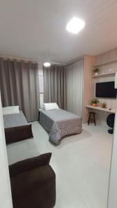 Giường trong phòng chung tại Condomínio da Fé +10 ảnh